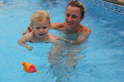 mum and baby swimming smiling